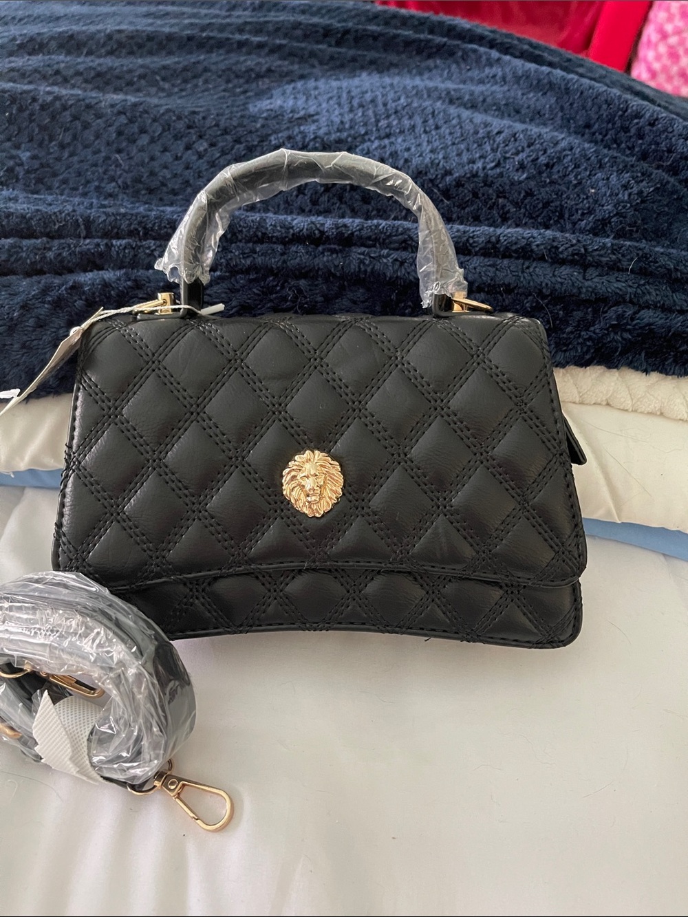 Black Quilted Top-Handle Bag with Gold Lion Accent